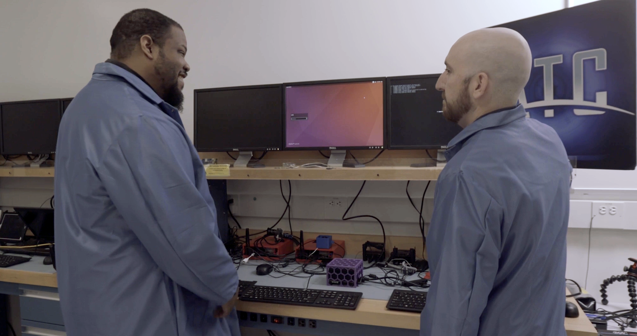 Dr. Bennie Lewis confers with Aaron Christian as their team brings advanced AI software together with physical hardware.