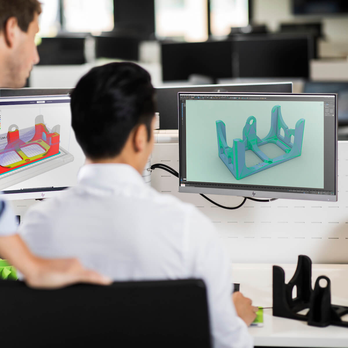 Engineers using CAD to design for 3D printing