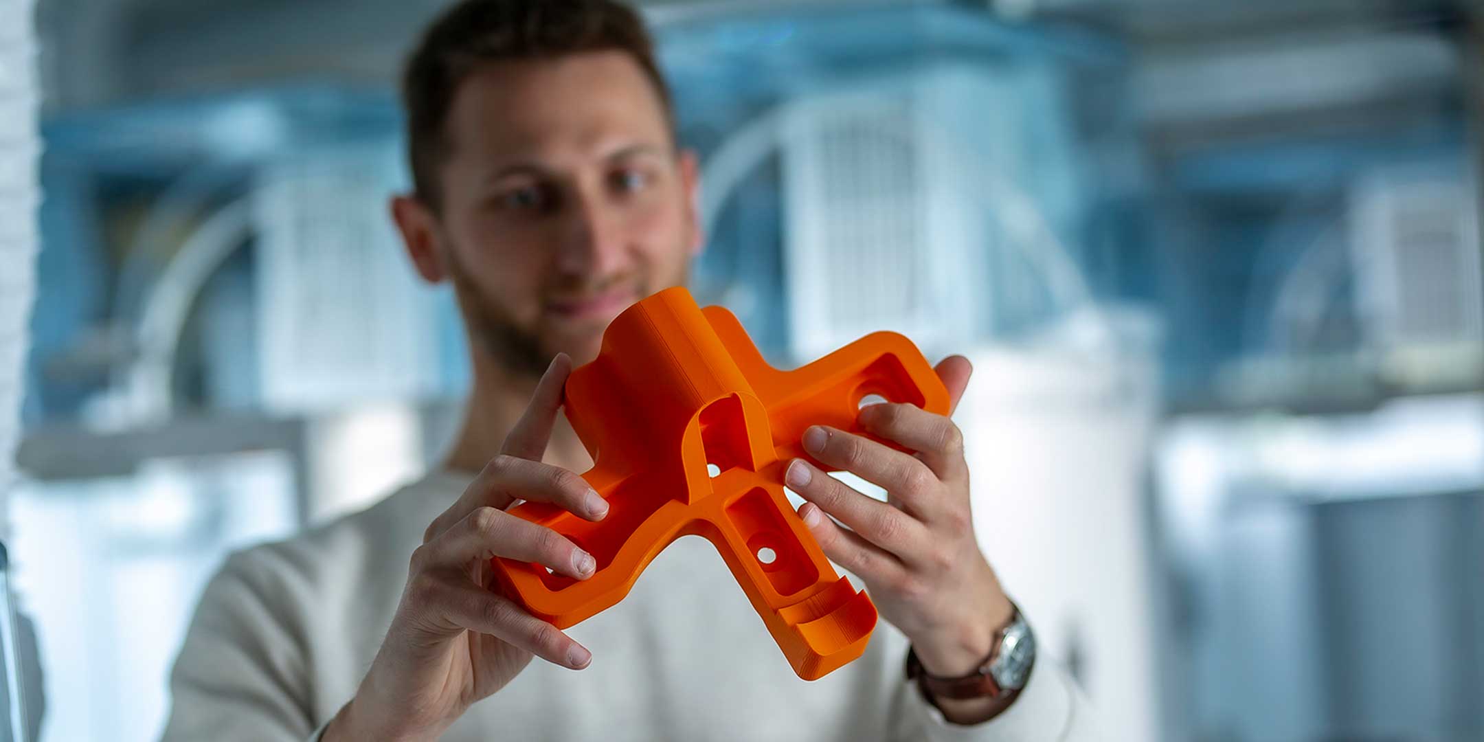 An application engineer inspecting a 3D print